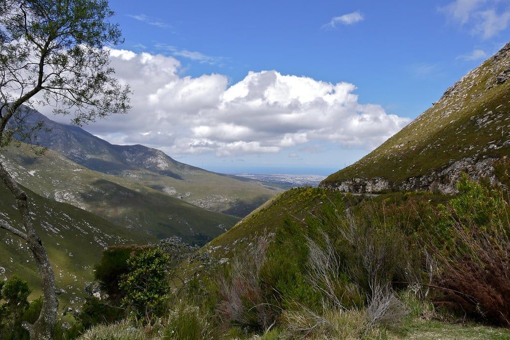 Lush green mountain slopes and the winding Outeniqua Pass overlooking the coastal plains near George along the Garden Route.